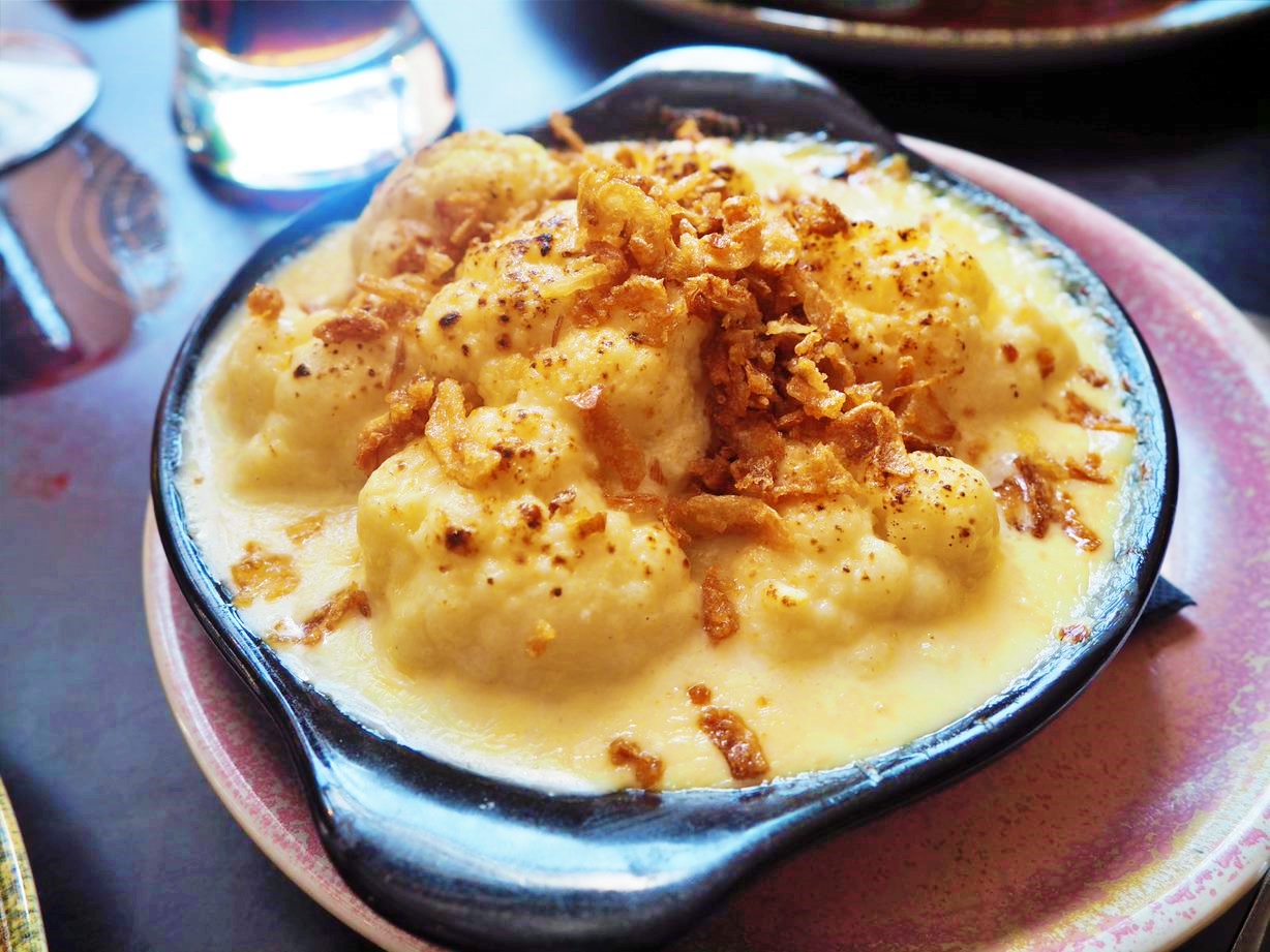 Cauliflower cheese in a black dish